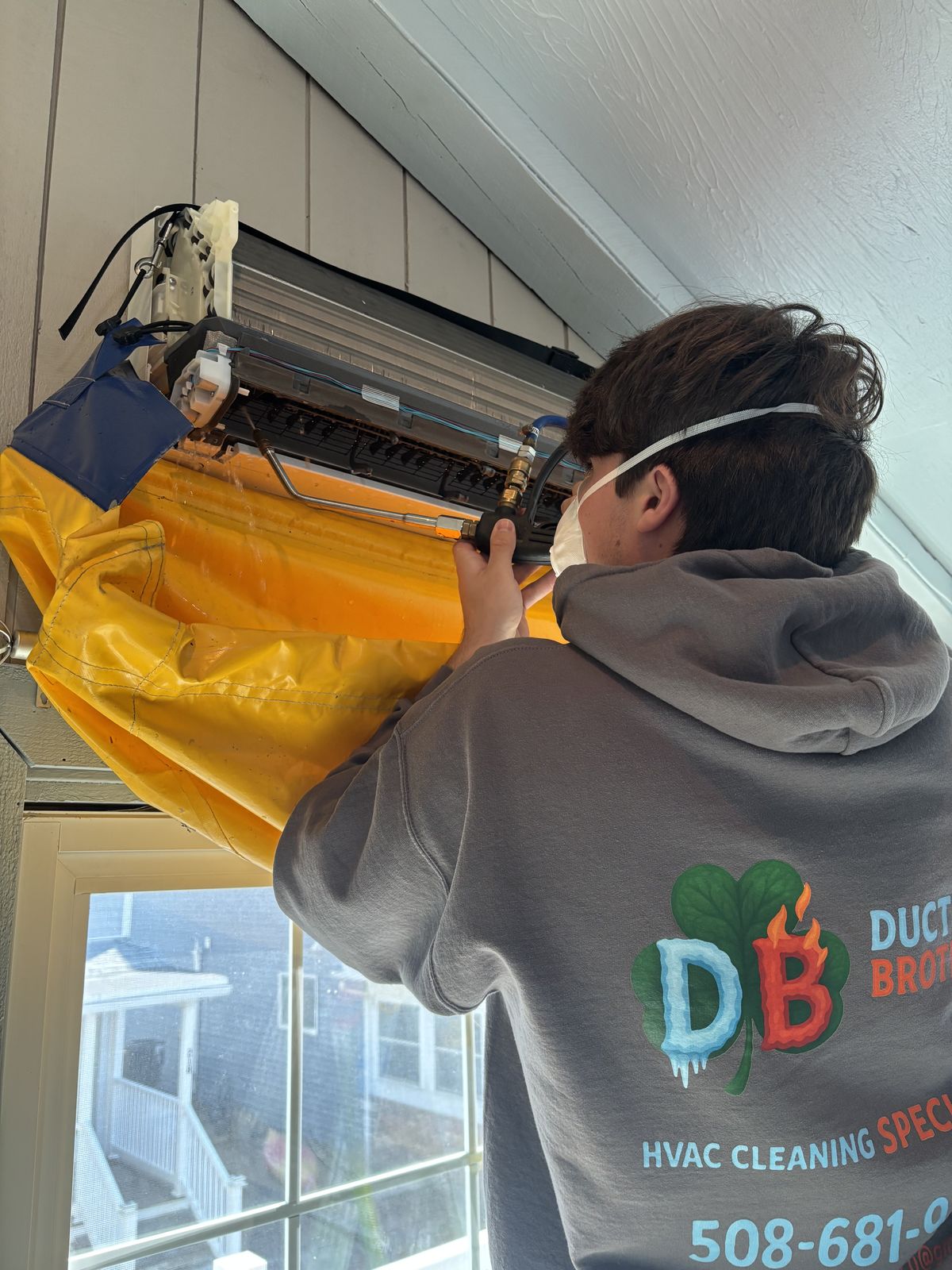 Ductless Brothers technician cleaning a mini-split indoor unit